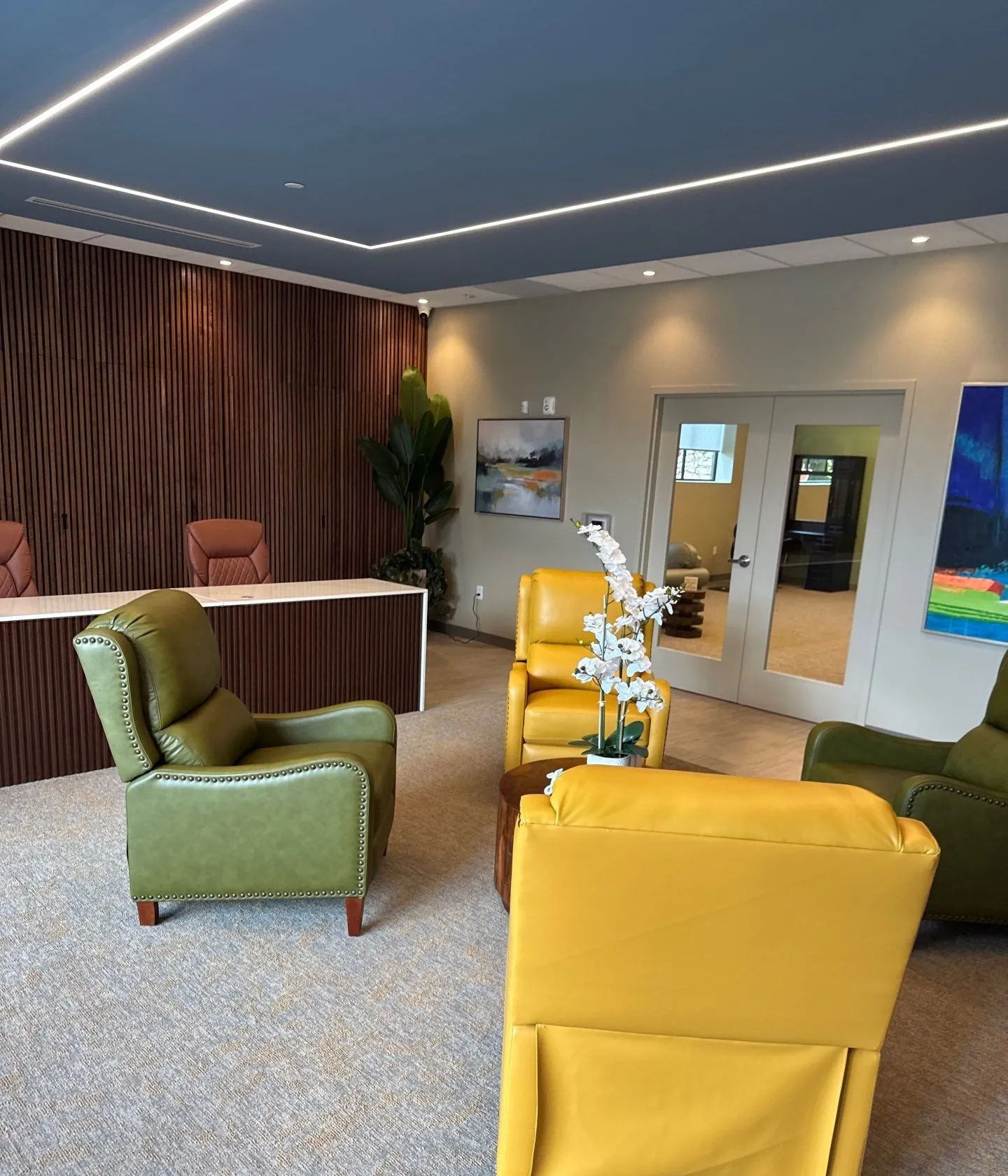 Finished reception area with wood slat feature wall and ceiling lighting in Kansas City