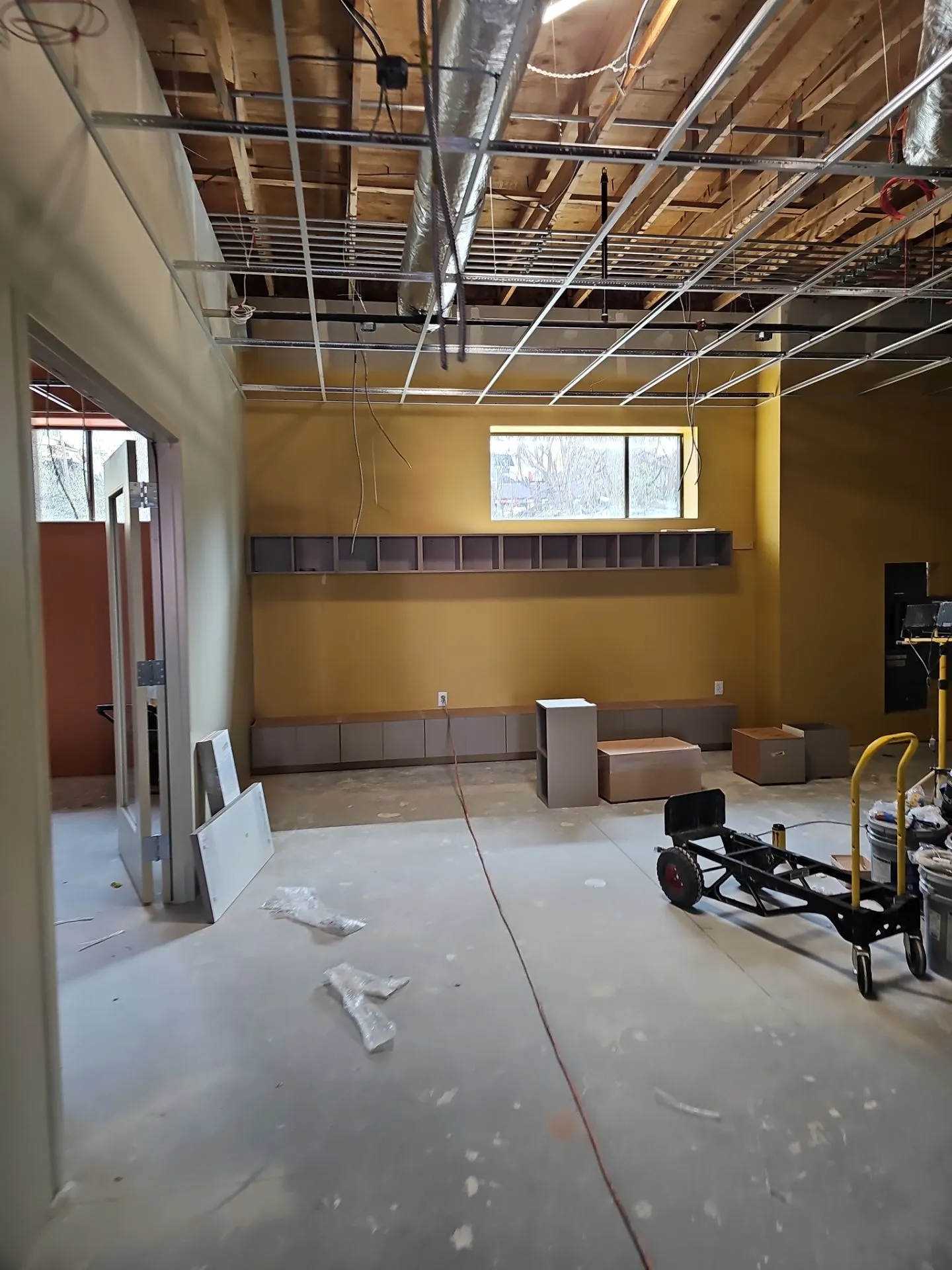 Painted accent wall and built-in cubbies during a Kansas City tenant finish